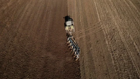 Tractor plowing field, drone view. Cultivated land and soil tillage. Stock Footage 191677106