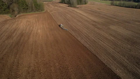 Tractor plowing field, drone view. Cultivated land and soil tillage. Video stock 191837611