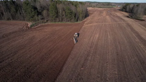 Tractor plowing field, drone view. Cultivated land and soil tillage. 動画素材 191837821