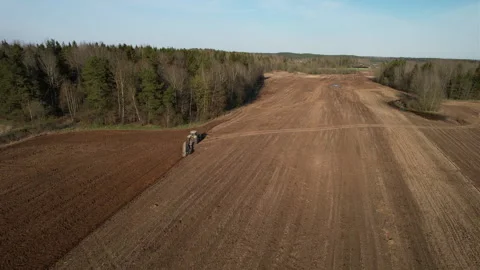 Tractor plowing field, drone view. Cultivated land and soil tillage. Video stock 191841686