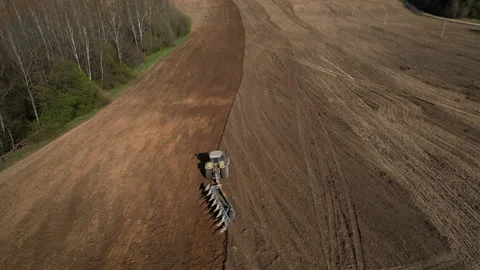 Tractor plowing field, drone view. Cultivated land and soil tillage. 스톡 동영상 191843258
