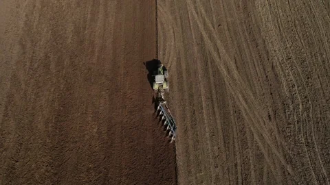 Tractor plowing field, drone view. Cultivated land and soil tillage. 動画素材 191843262