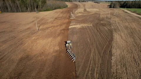 Tractor plowing field, drone view. Cultivated land and soil tillage. Stockbeeldmateriaal 191843492