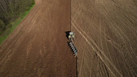 Tractor plowing field, drone view. Cultivated land and soil tillage. 스톡 동영상 191845213