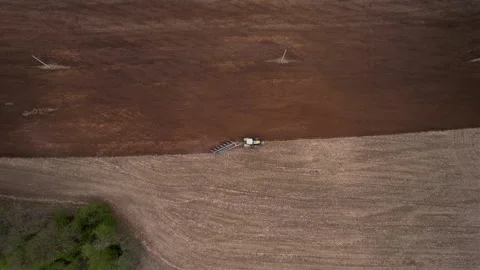 Tractor plowing field, drone view. Cultivated land and soil tillage. Stockbeeldmateriaal 193978030