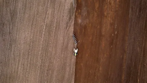 Tractor plowing field, drone view. Cultivated land and soil tillage. Stock Footage 193980340