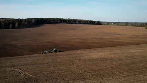 Tractor plowing field, drone view. Cultivated land and soil tillage. Stockbeeldmateriaal 193981634