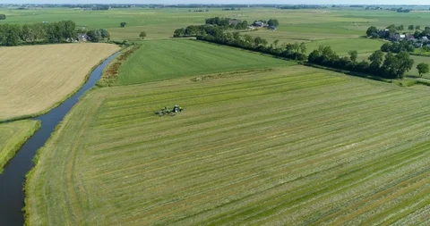 Tractor Plowing a Field, Flat Landscape, Friesland, The Netherlands – 4K Drone Stock Footage 120829204