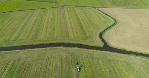 Tractor Plowing a Field, Flat Landscape, Friesland, The Netherlands – 4K Drone Video stock 120829825