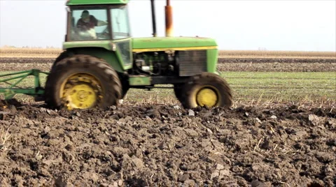 Tractor plowing a field Stock Footage 1046810