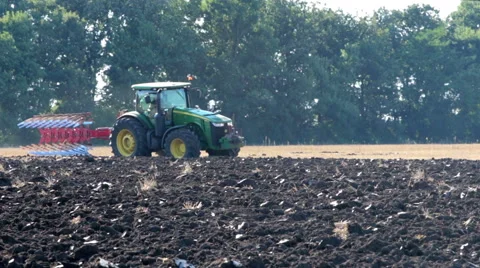 Tractor plowing a field Stock Footage 53066943