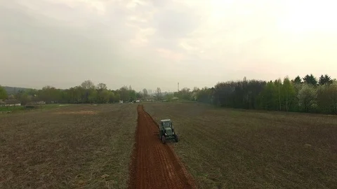 Tractor plowing field Stock Footage 86908771