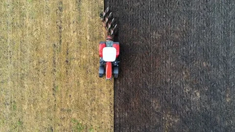 Tractor Plowing a Field Stock Footage 132376848