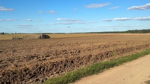 Tractor plowing the field Видео 247964226