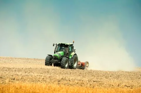 Tractor plowing field Stock Photos