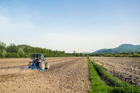 Tractor plowing field Stock Photos