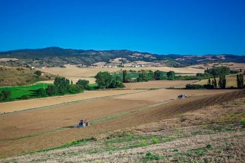 Tractor plowing field Stock Photos