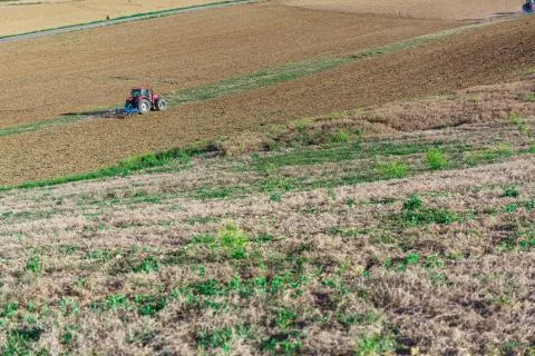 Tractor plowing field Stock Photos
