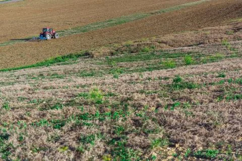 Tractor plowing field Stock Photos