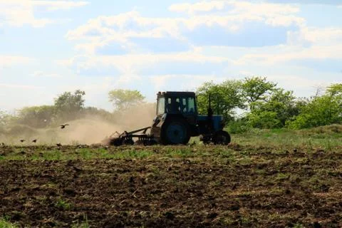 Tractor is plowing a field Stock Photos
