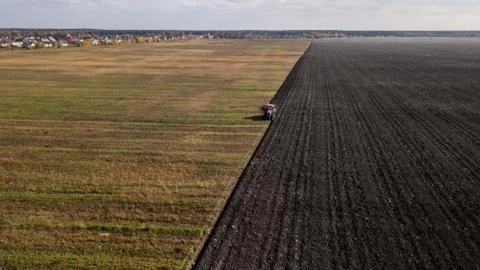 Tractor plowing the field Stock Photos