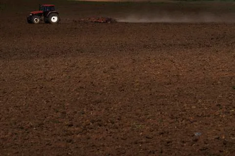 Tractor plowing the field Stock Photos