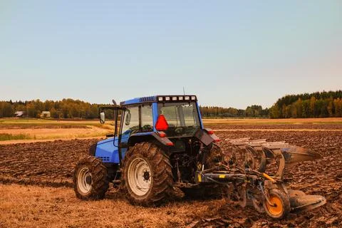 Tractor plowing the field Stock Photos