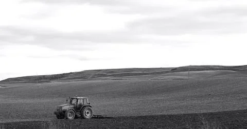 Tractor plowing the field Stock Photos