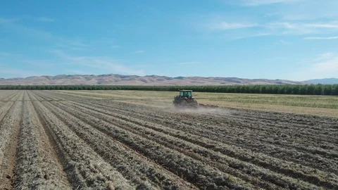 Tractor Plowing Field With Rolling Mountain View Stock Footage 89594170