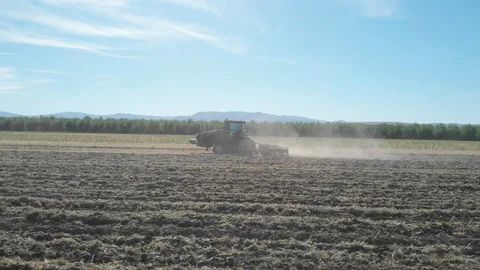 Tractor Plowing Field With Rolling Mountain View Stock Footage 89783713