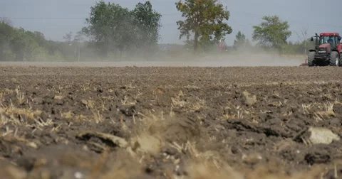 Tractor is Plowing Field Soil Driver's Silhouette Tractor is Passing by Camera Stock Footage 53606884