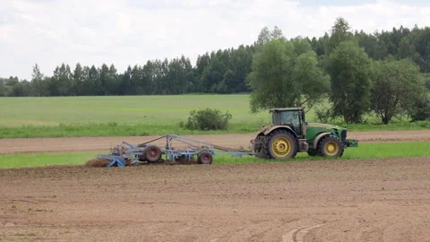 Tractor plowing the field in spring Stock Footage 276821122