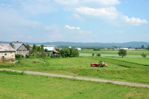 Tractor plowing the field in spring,poland Stock Photos