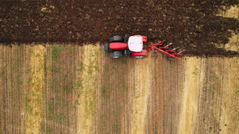 Tractor Plowing field on sunset. Big Tractor During Field Cultivating. Stock Footage 191915421