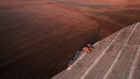 Tractor Plowing field on sunset. Cultivated land and soil tillage. 스톡 동영상 167561007