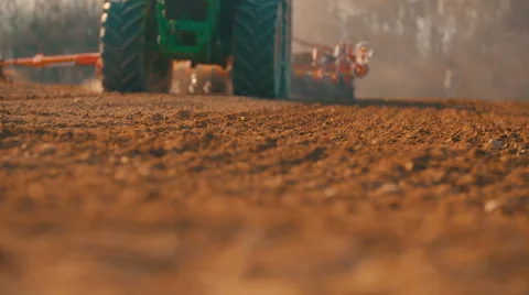 Tractor plowing field at sunset - high angle agriculture background Stock Footage 61467465