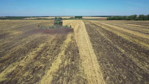 Tractor plowing the field top view aerial photography from a quadcopter Stock Footage 137007203