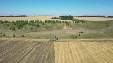 Tractor plowing the field top view aerial photography from a quadcopter Video stock 137010900