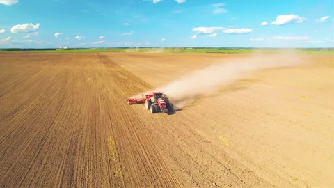 Tractor plowing field. Tractor plow soil cultivating. Sowing seeds Stock Footage 167560431