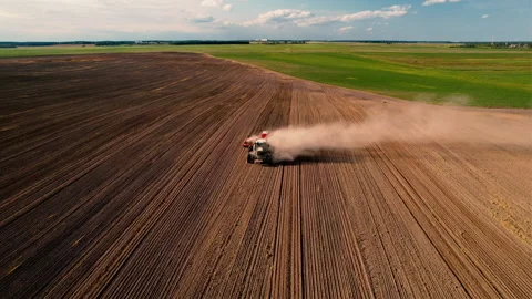 Tractor plowing field. Tractor plow soil cultivating. Sowing seeds Stock Footage 167562325