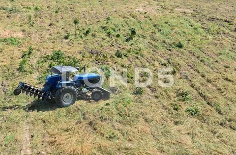 Tractor plowing the fields Stock Photos
