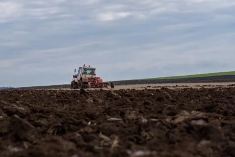 Tractor plowing fields. Stock Photos