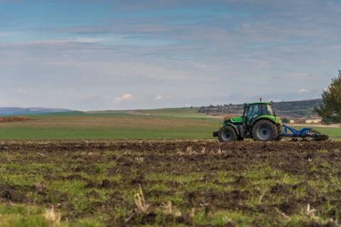 Tractor plowing fields. Stock Photos