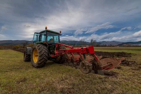 Tractor plowing fields. Stock Photos