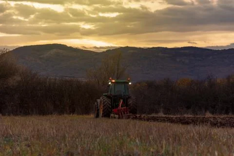 Tractor plowing fields Stock Photos