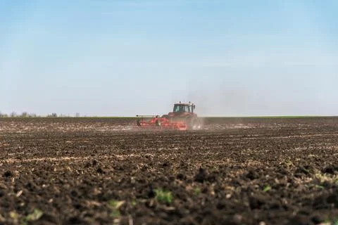 Tractor plowing fields. Stock Photos