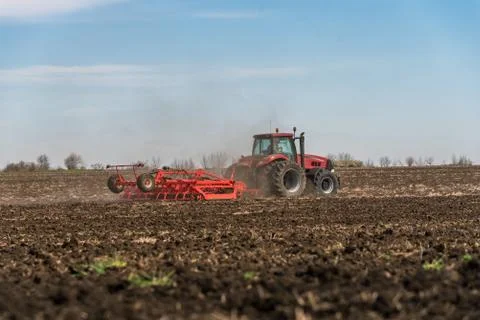 Tractor plowing fields. Stock Photos