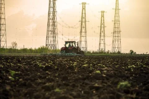 Tractor plowing fields. Stock Photos