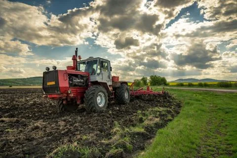 Tractor plowing fields. Stock Photos