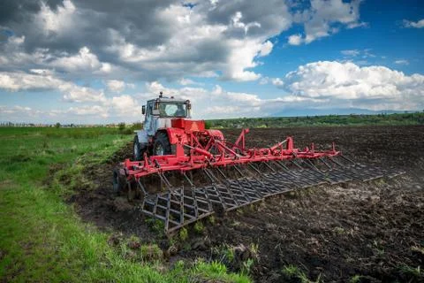 Tractor plowing fields. Stock Photos
